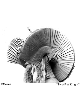 a very structured head topper, paper hat by Moses.
