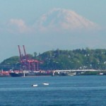 Container cranes of Seattles port with the ghostly shadow of Mt. Rainier looming in the background &copy; Mahalie Pech